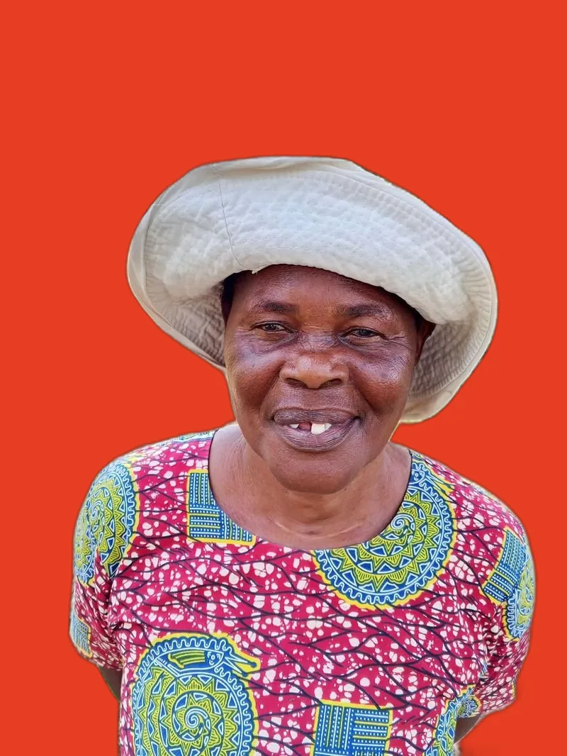 Smiling farmer in a straw hat on red, Siaya, Kenya