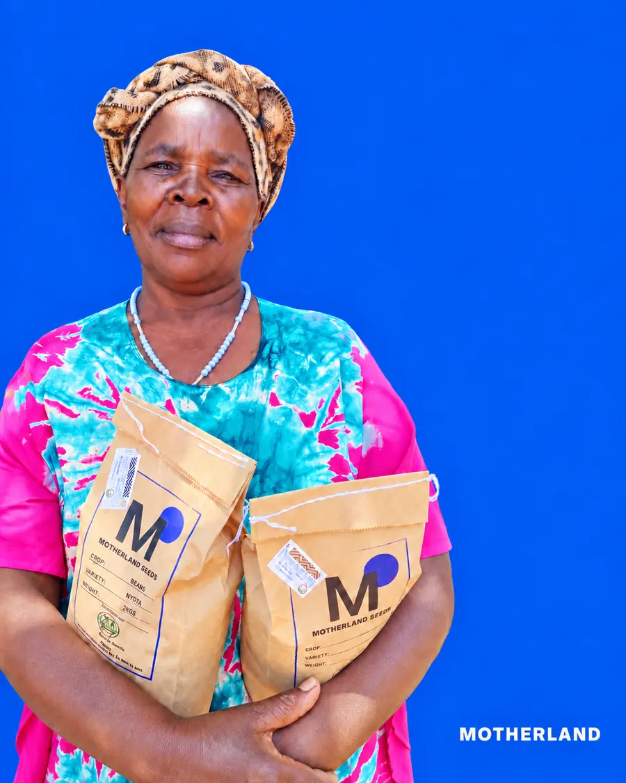 Farmer holding two bags of MOTHERLAND SEEDS